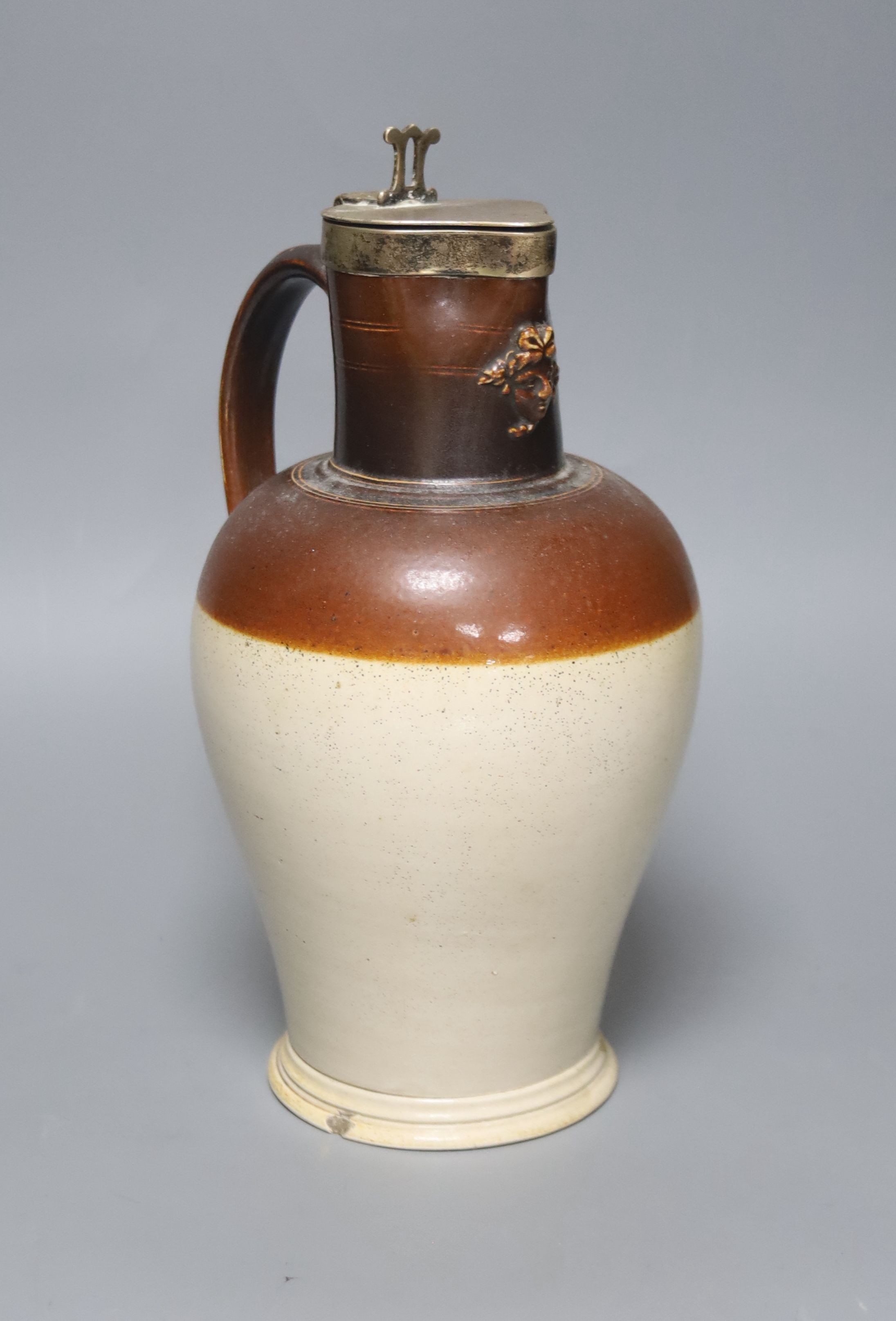 A silver mounted stoneware pitcher ‘presented by Joseph Neeld Esq to Joseph Cirvers 1848’ the base marked ‘Hot water proof’ 26cm